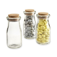 Milk-bottle favor measures approximately 4''h Clear, milk bottle-shaped favor jar with round